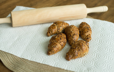 homemade fresh croissant with sesame on placemat table.