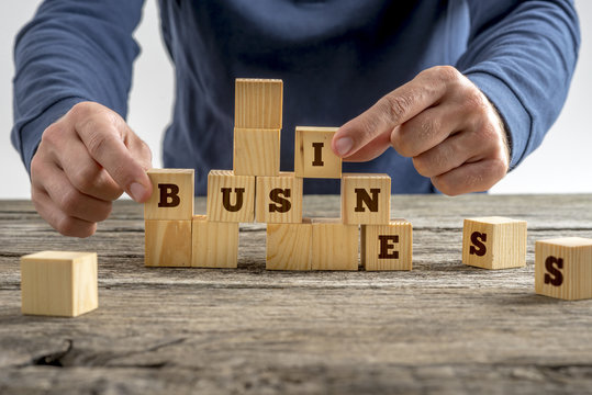Man building the word Business with blocks