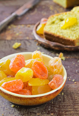 cake with kumquats and poppy seed on wooden background
