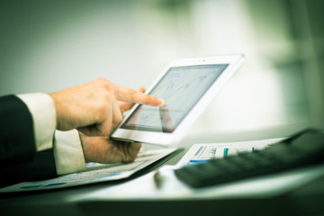 Businessman with finger touching screen of a digital tablet