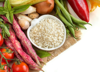 White rice in bowl and fresh vegetables