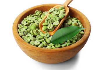 Green coffee beans with leaf in bowl isolated on white