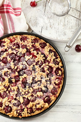 Tasty homemade pie with cherries on table close up