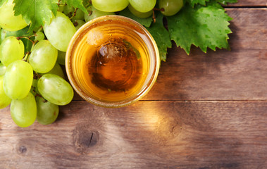 Glass of cool grape juice on wooden table, closeup
