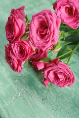 Beautiful roses on wooden background