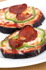 pizza on grilled eggplant slices on table