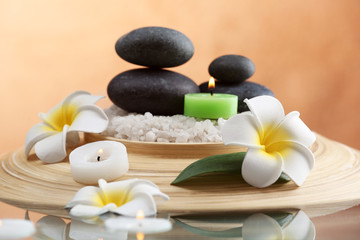 Still life with spa stones on brown background