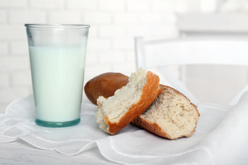 Milk with bread on table in kitchen