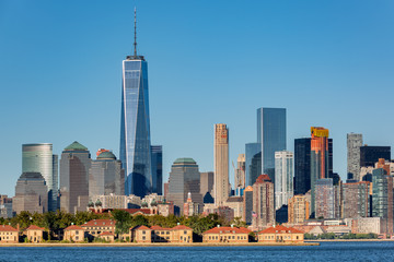 Downtown New York skyline with Ellis Island in the foreground - obrazy, fototapety, plakaty
