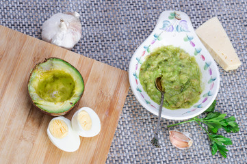 Avocado paste with egg, cheese and garlic