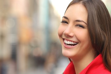Woman white smile with a perfect teeth in the street
