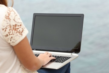 Woman working with a laptop and showing the display