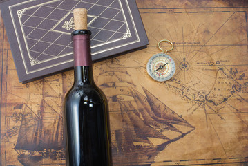 bottle of wine  on the background of old maps