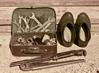Vintage suitcase with plumbing tools