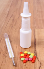 Pills, thermometer and nose drops and for colds, treatment of flu and runny