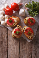 crostini with tomatoes, olives and cheese. vertical top view
