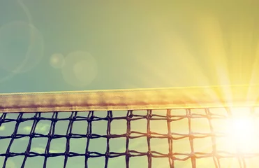 Zelfklevend Fotobehang Tennis net with sunset sky in the background © vencav