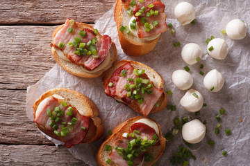 crostini with bacon and mozzarella closeup. horizontal top view
