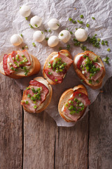 Delicious crostini with bacon and mozzarella cheese. vertical top view
