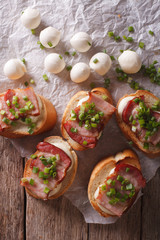 Delicious crostini with bacon and mozzarella closeup. vertical top view
