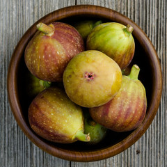 group of figs in a bowl - rustic wooden table
