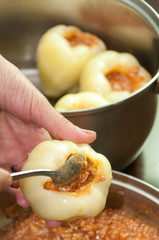 Stuffing fresh paprika with cooked minced meat