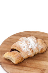 Puff pastry with fruit jam on the wooden board