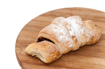 Puff pastry with fruit jam on the wooden board