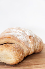 Puff pastry with fruit jam on the wooden board