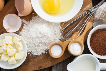 Baking ingredients on a wooden board, horizontal, top view