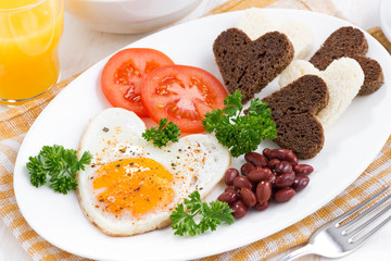 fried eggs in the form of heart for breakfast Valentine's Day 