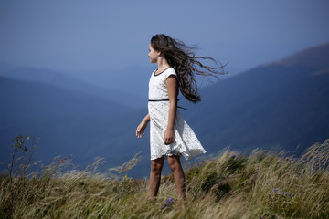 Naklejka premium Small girl in mountains