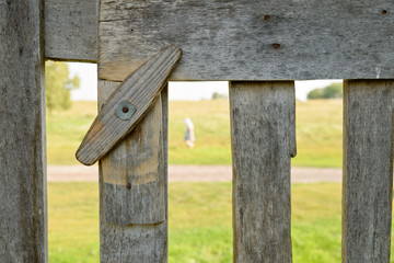 Fragment of a wooden fence with a revolving latch