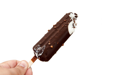 Chocolate ice cream on a stick in hand