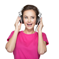 Cheerful young woman listening music with headphones