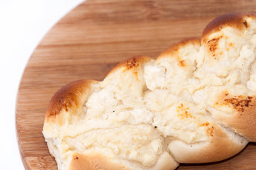 Pastry stuffed with cheese on the wooden board