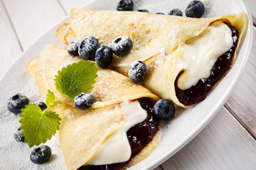 Crepes with blueberries and cream