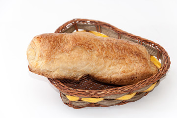 Pastry stuffed with ham and cheese in the wooden basket