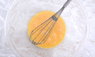 Whisk in a bowl of beaten eggs
