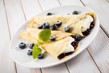 Crepes with blueberries and cream