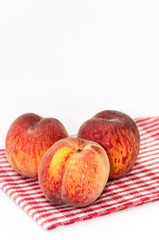 Fresh peaches on the kitchen tablecloth