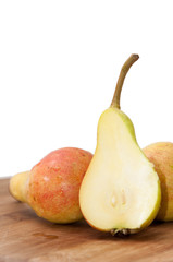 Fresh little sweet pears sliced on the wooden board