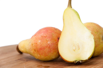 Fresh little sweet pears sliced on the wooden board