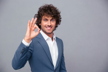 Smiling businessman showing ok sign