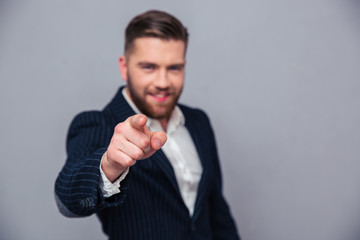 Portrait of a businessman pointing finger at camera