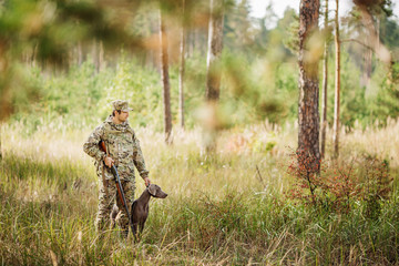 yang Hunter with Rifle and Dog in forest © kaninstudio