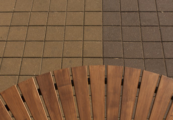 New wooden bench and pavement.