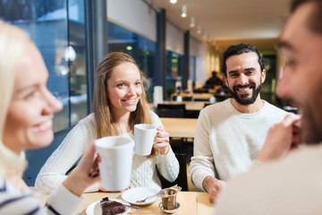happy friends meeting and drinking tea or coffee
