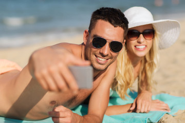 Fototapeta premium happy couple in swimwear walking on summer beach