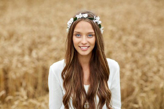 smiling young hippie woman on cereal field